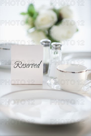 Close up of place setting with reserved sign.