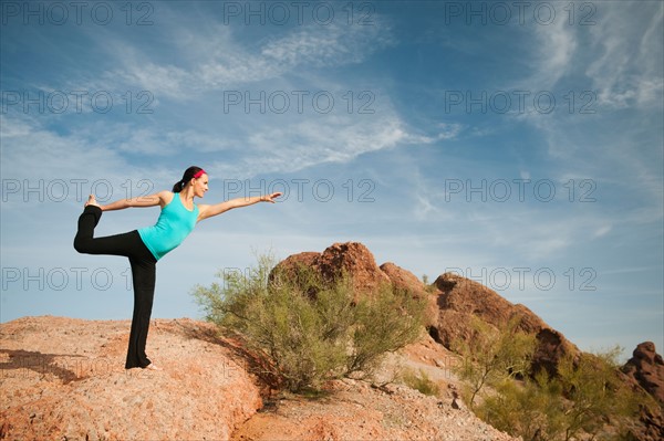 USA, Arizona, Phoenix, Young woman exercising on desert.