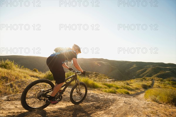 USA, California, Laguna Beach, Mountain biker riding downhill.