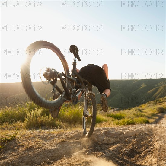 USA, California, Laguna Beach, Mountain biker falling of his bike.