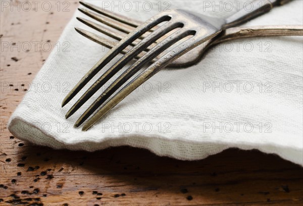 Two forks on napkin.