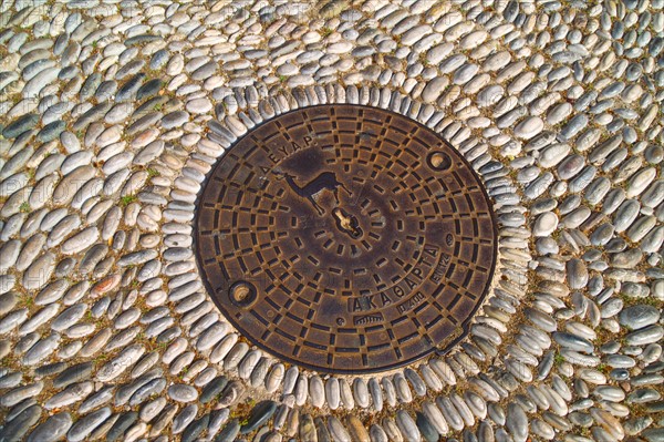 Greece, Rhodes, Manhole cover with symbol of Rhodes.