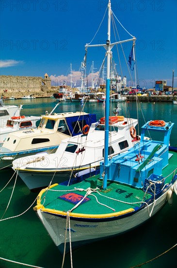 Greece, Rhodes, Harbor and old town wall.