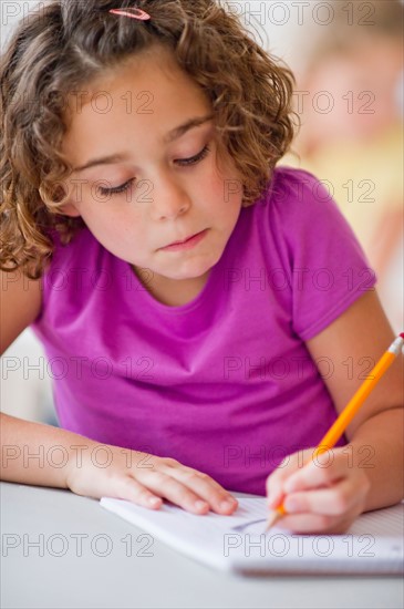 Girl (6-7) taking exam.