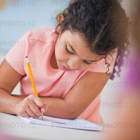 Girl (8-9) taking exam.