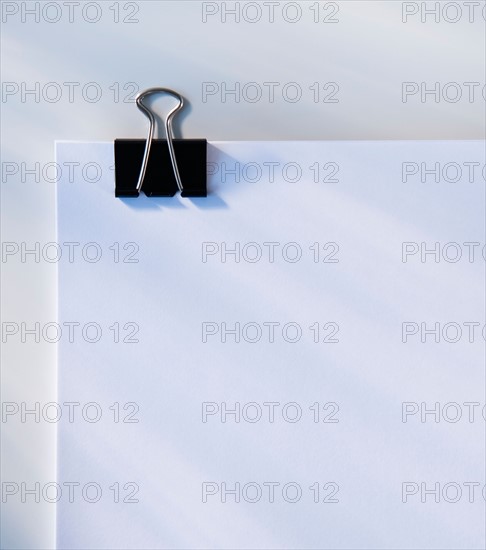 Paper with clip, studio shot. Photo : Daniel Grill