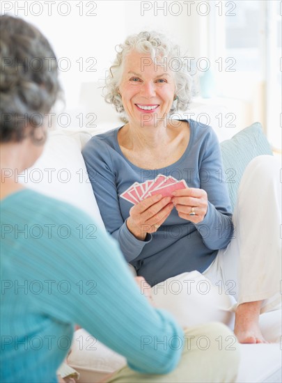 Two senior women playing cards. Photo : Daniel Grill