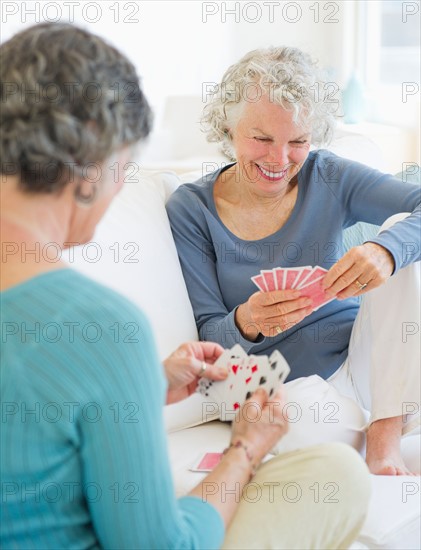 Two senior women playing cards. Photo : Daniel Grill