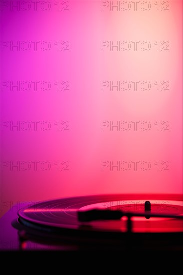 Close up of turntable on pink background. Photo: Daniel Grill