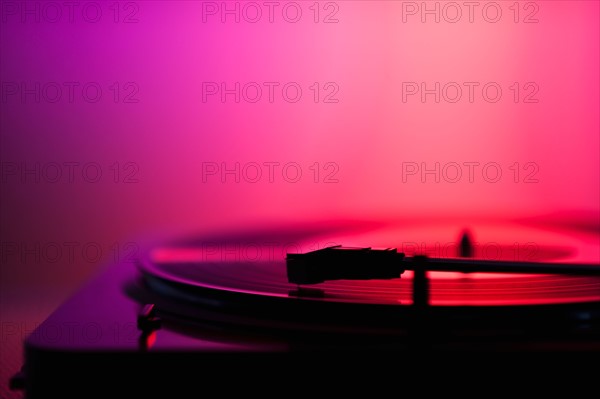 Close up of turntable on pink background. Photo: Daniel Grill
