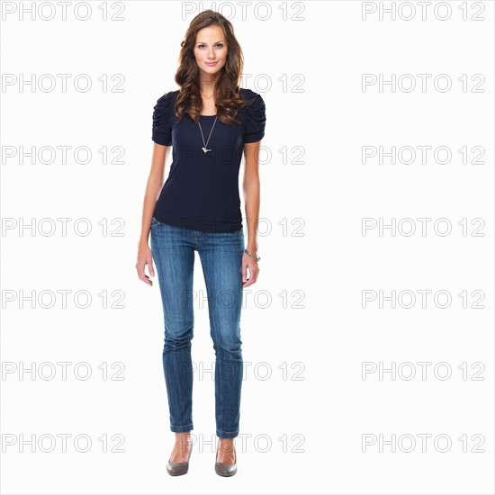 Studio shot of young beautiful woman standing on white background. Photo : momentimages