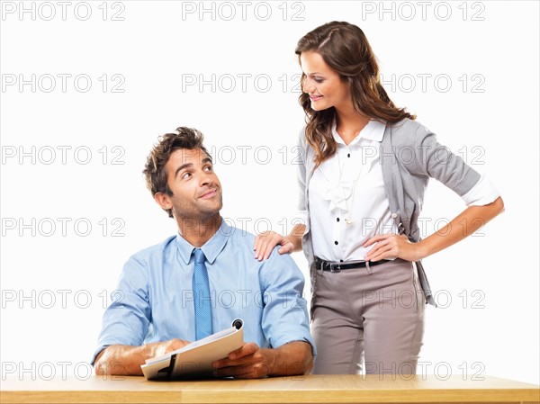 Business woman and business man reading document together. Photo : momentimages