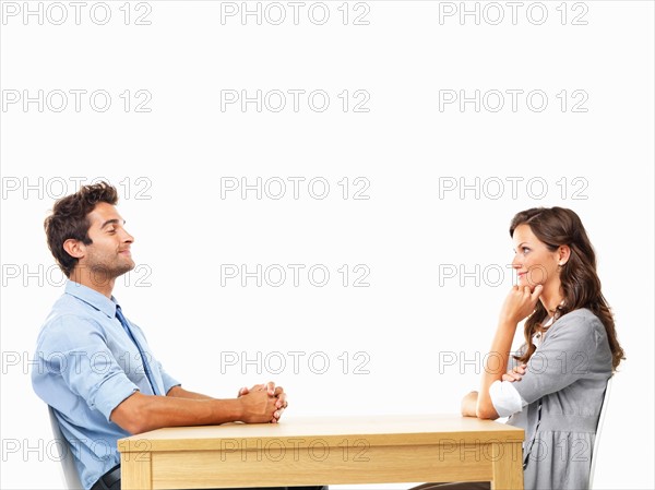 Business couple sitting at table for date. Photo: momentimages