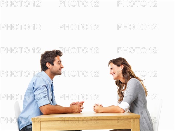 Business couple sitting at table for date. Photo: momentimages