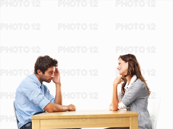 Business couple sitting at table for date. Photo : momentimages