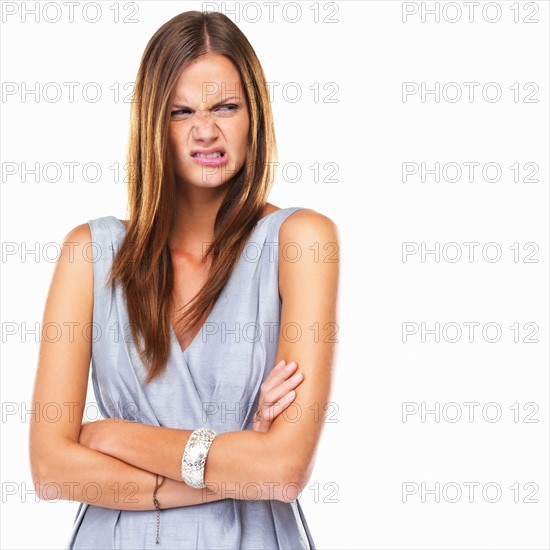 Portrait of disgusted woman standing with hands folded. Photo: momentimages