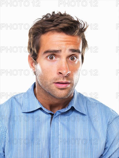 Studio portrait of young of shocked business man. Photo : momentimages
