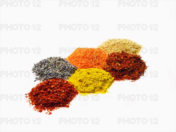 Studio shot of Piles of spice on white background. Photo : David Arky