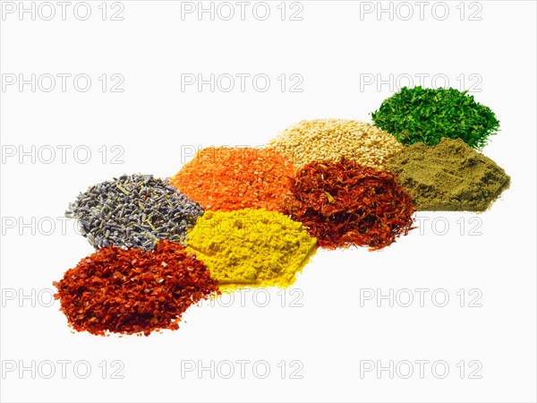 Studio shot of Piles of spice on white background. Photo : David Arky