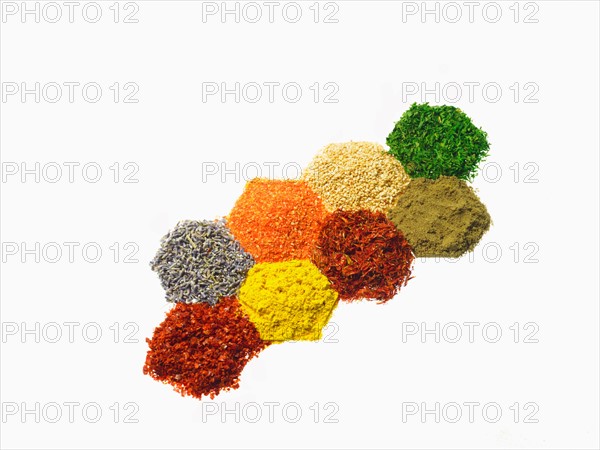 Studio shot of Piles of spice on white background. Photo : David Arky