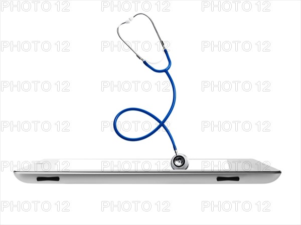 Studio shot of stethoscope coming out from digital tablet. Photo : David Arky