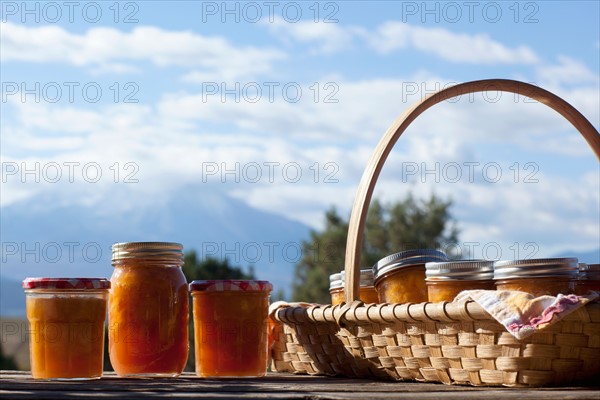 Basket full of jars with preserves. Photo : Noah Clayton