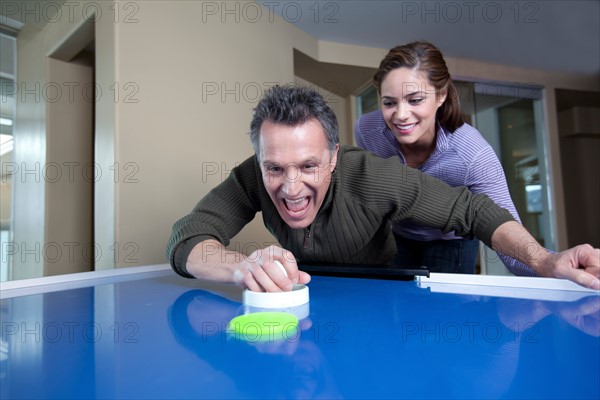 Couple playing air Hockey