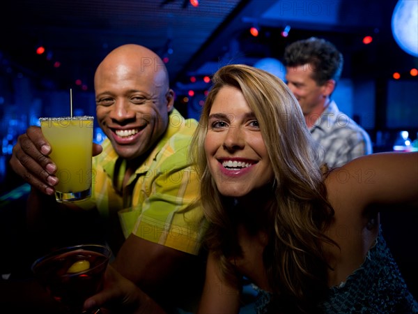 Friends enjoying drinks at bar. Photo : db2stock