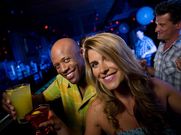 Friends enjoying drinks at bar. Photo : db2stock