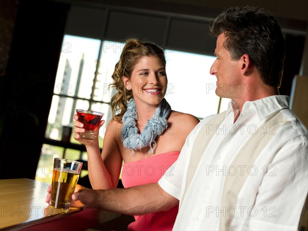 Friends enjoying drinks at bar. Photo : db2stock