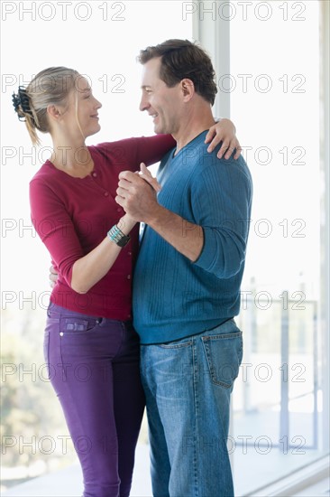 Mature couple dancing in empty living room. Photo : Rob Lewine