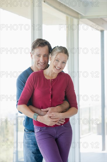 Mature couple in empty living room. Photo : Rob Lewine