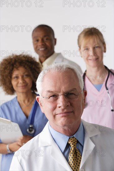 Portrait of four medical professionals, studio shot. Photo: Rob Lewine