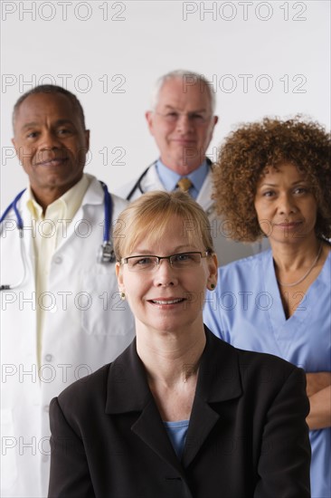 Portrait of four medical professionals, studio shot. Photo : Rob Lewine