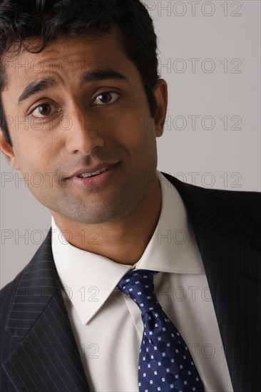 Portrait of young businessman, studio shot. Photo : Rob Lewine