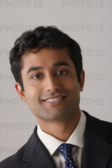 Portrait of young businessman, studio shot. Photo : Rob Lewine