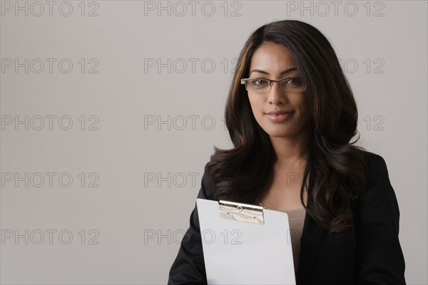Portrait of young businesswoman, studio shot. Photo : Rob Lewine