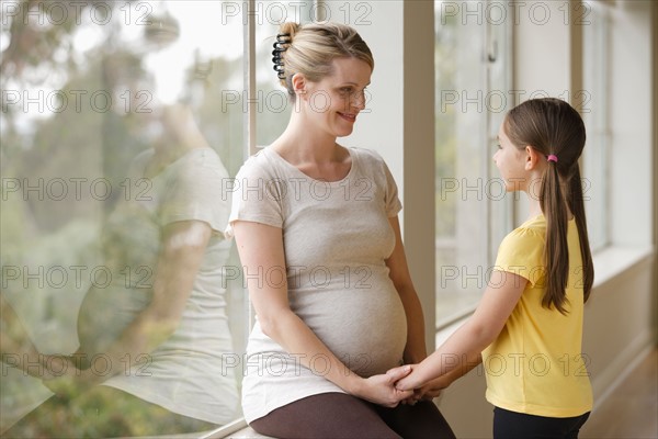 Pregnant woman with daughter (6-7). Photo : Rob Lewine