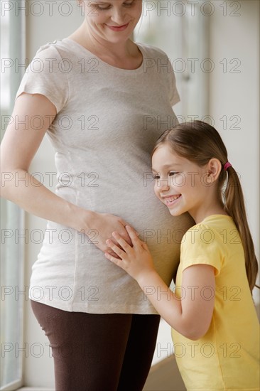 Pregnant woman with daughter (6-7). Photo : Rob Lewine