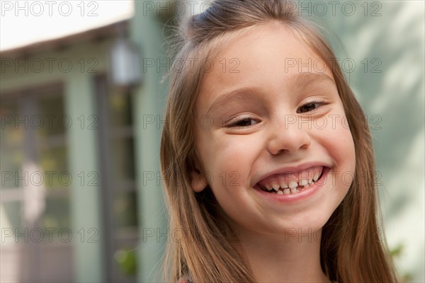 Portrait of cheerful girl (6-7). Photo : Rob Lewine