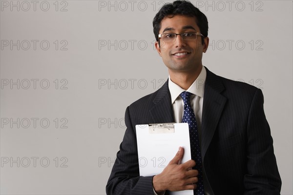 Portrait of young businessman, studio shot. Photo : Rob Lewine