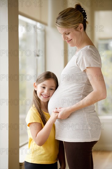 Pregnant woman with daughter (6-7). Photo : Rob Lewine