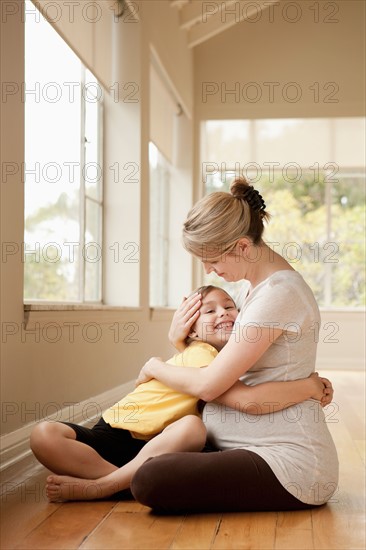 Daughter (6-7) embracing pregnant mother. Photo : Rob Lewine