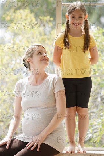 Daughter (6-7) standing next to pregnant mother. Photo: Rob Lewine