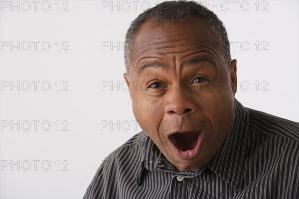 Portrait of mature man, studio shot. Photo : Rob Lewine