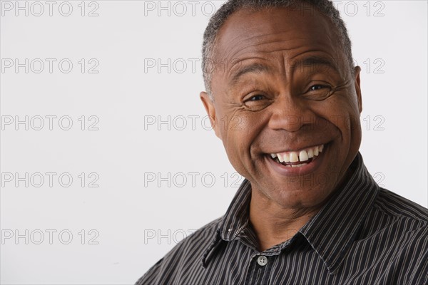 Portrait of mature man, studio shot. Photo : Rob Lewine