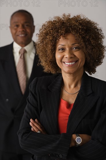 Mature business people, studio shot. Photo: Rob Lewine