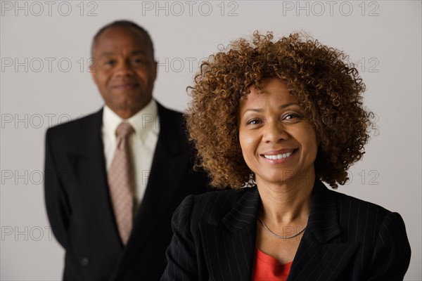 Mature business people, studio shot. Photo : Rob Lewine