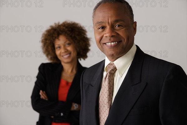 Mature business people, studio shot. Photo : Rob Lewine