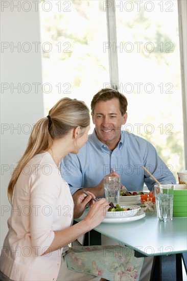 Mature couple eating meal. Photo : Rob Lewine